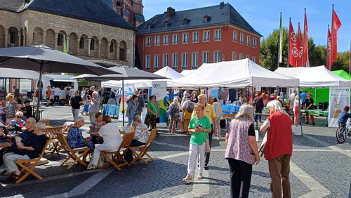 Stände auf einem Platz vor historischen Häusern. 
